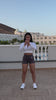 Frau macht in rb Sportkleidung outdoor workouts auf dem Balkon